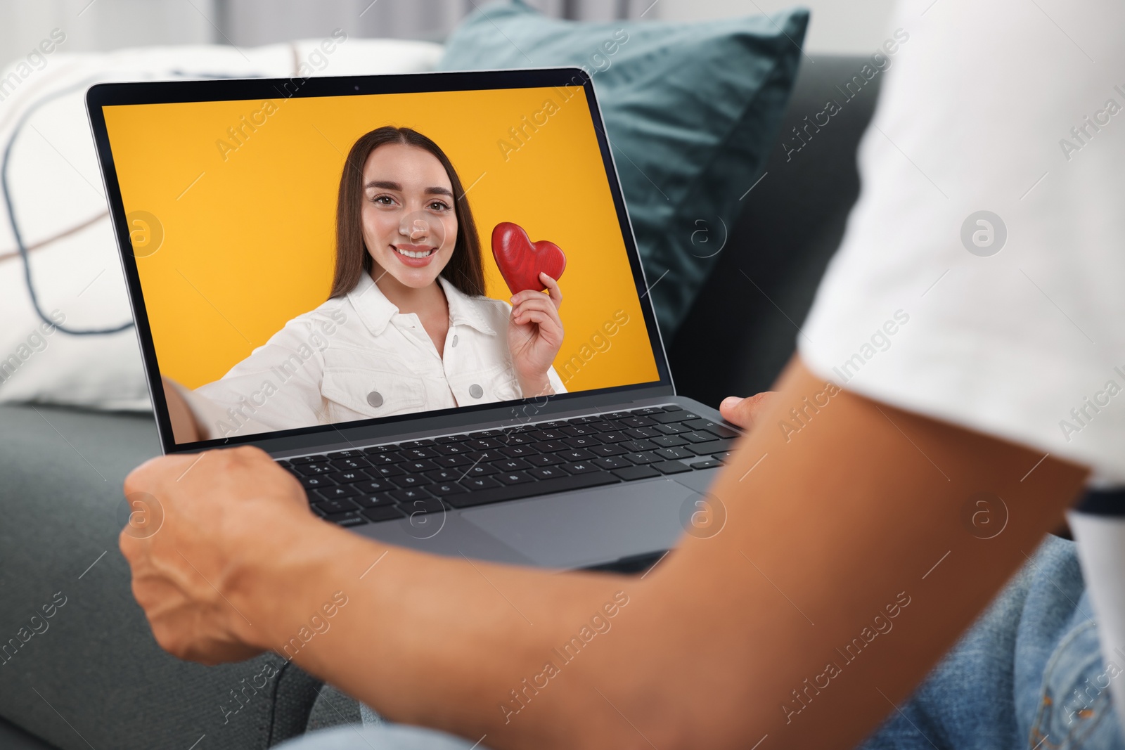 Image of Long distance love. Man having video chat with his girlfriend via laptop at home, closeup