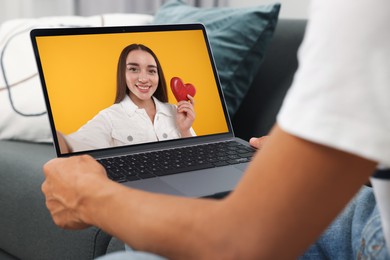 Image of Long distance love. Man having video chat with his girlfriend via laptop at home, closeup