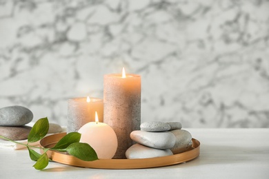 Composition with spa stones and candles on table. Space for text