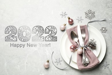 Image of Happy New 2022 Year! Beautiful table setting and festive decor on light grey marble background, flat lay