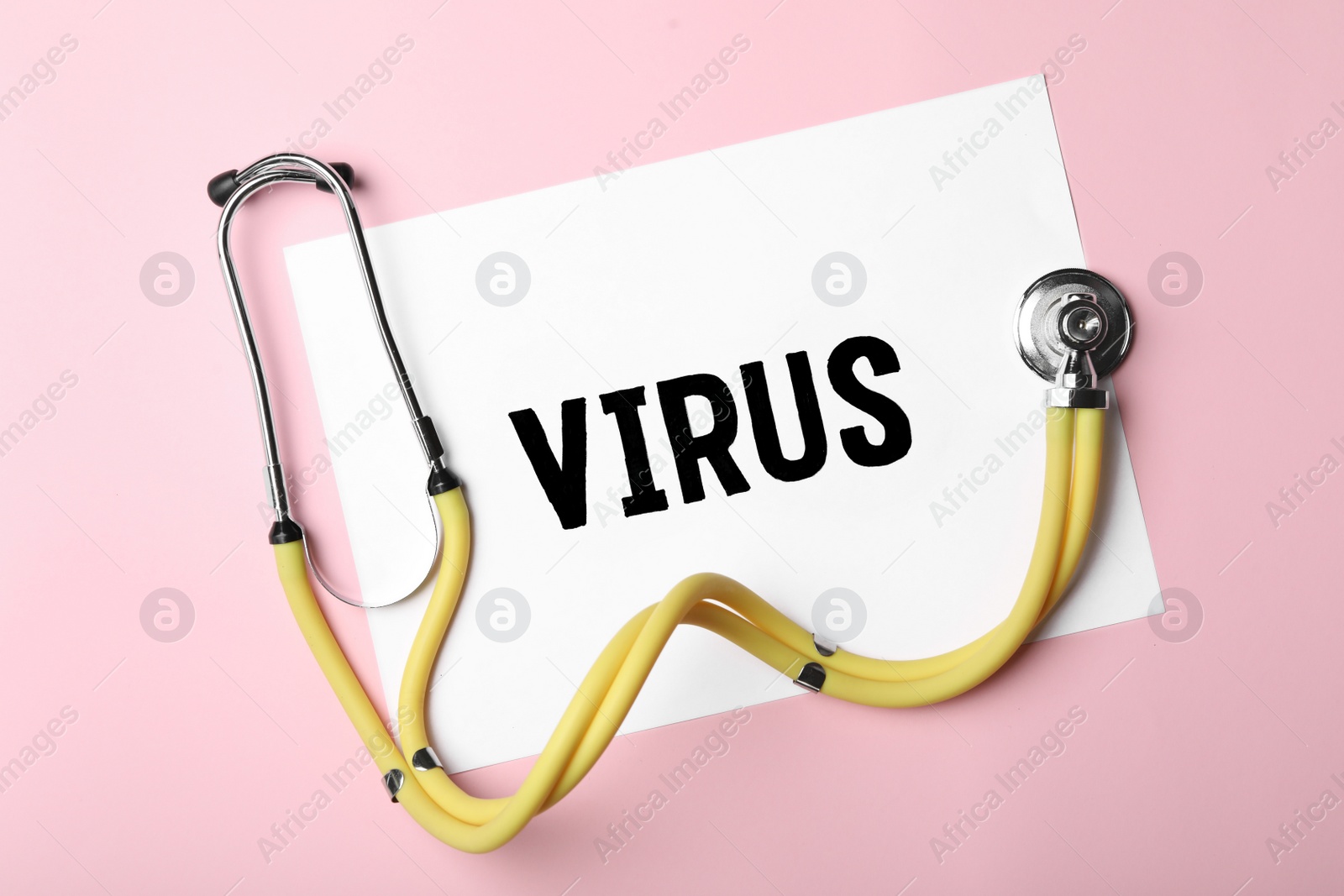 Photo of Paper with word VIRUS and stethoscope on pink background, flat lay