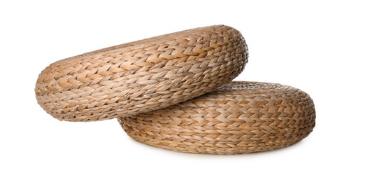 Photo of Two stylish wicker poufs on white background