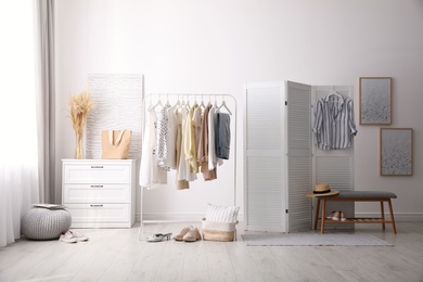 Photo of Dressing room interior with stylish white furniture