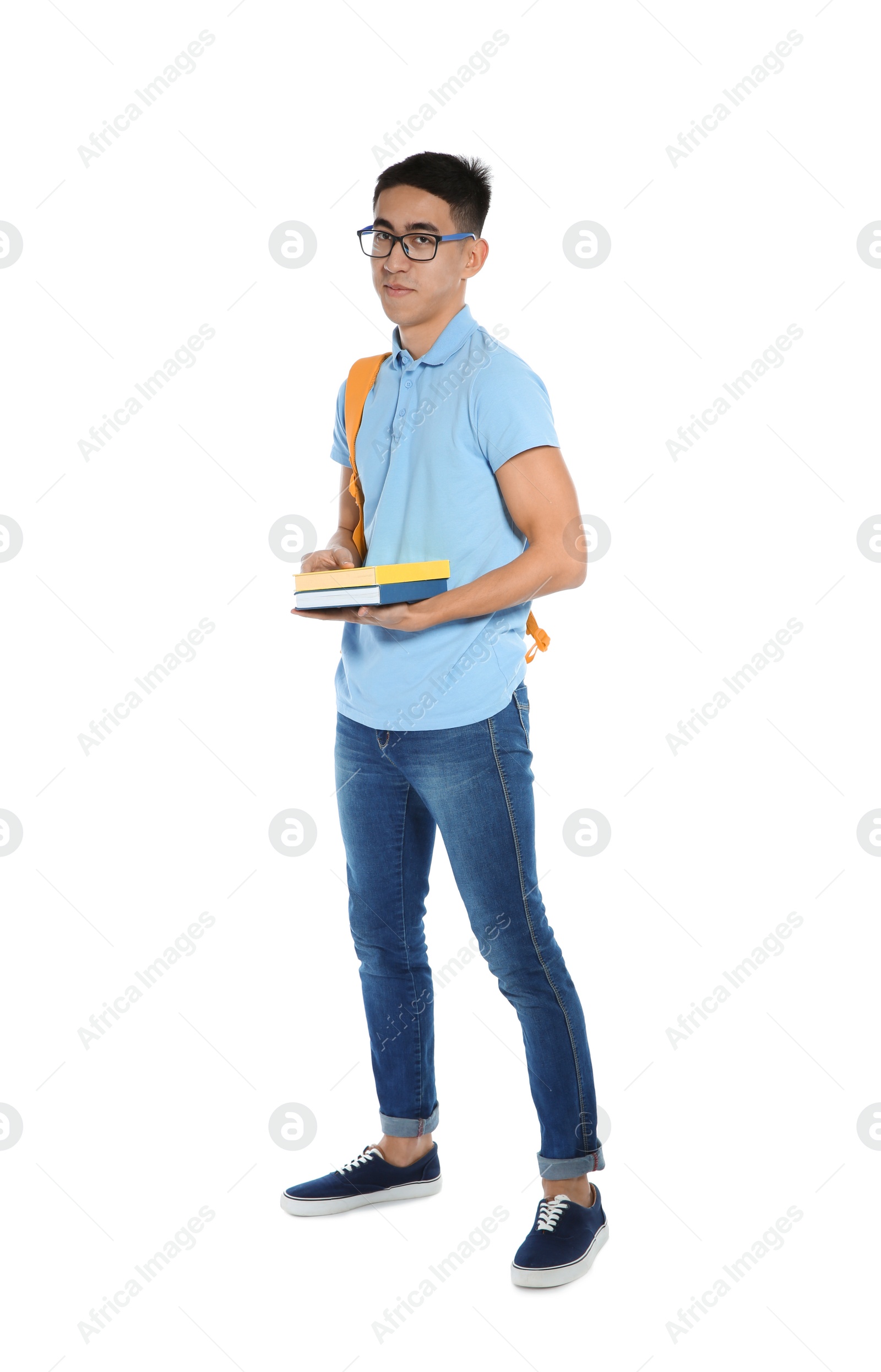 Photo of Asian teenager boy with books on white background