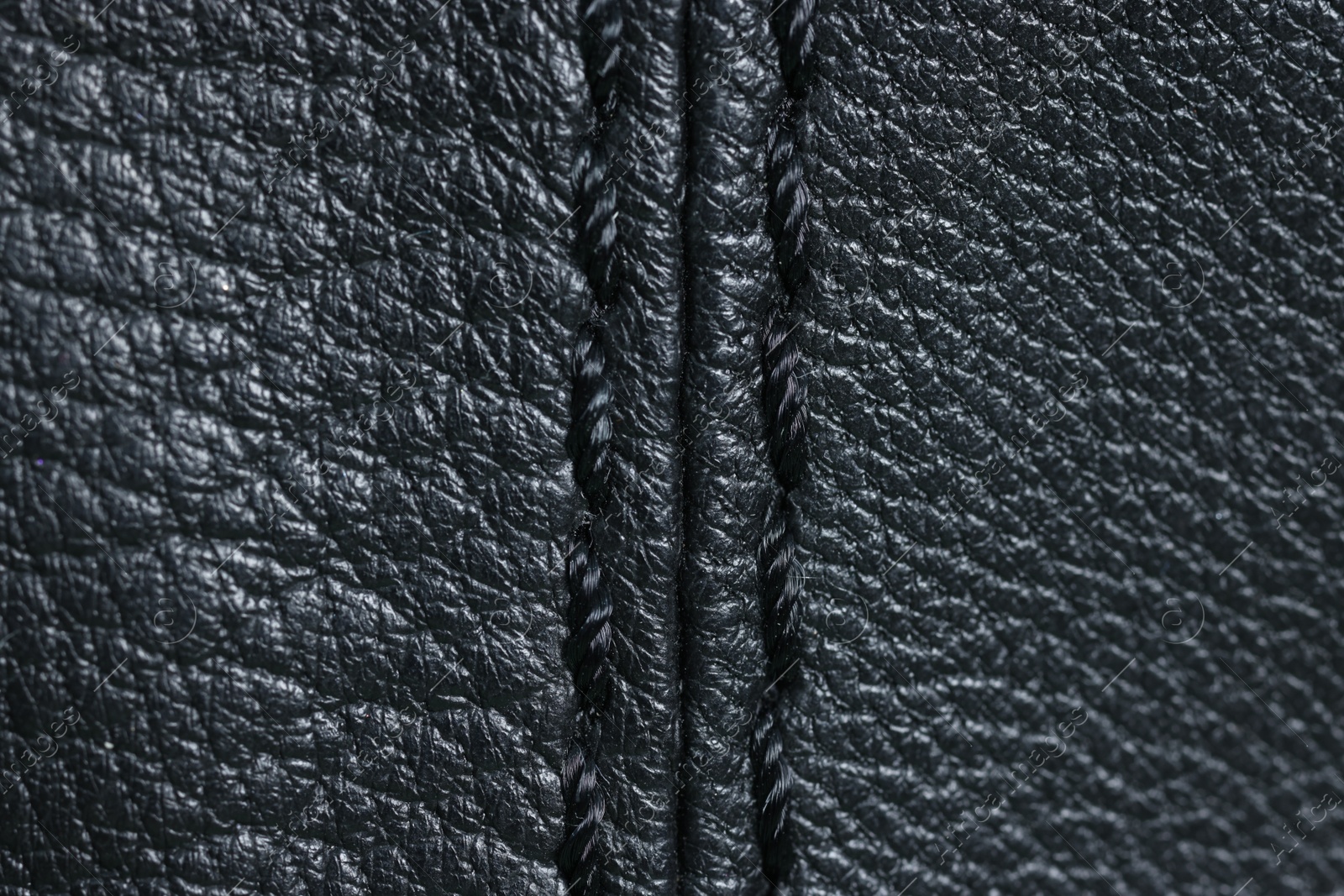 Photo of Black leather with seam as background, top view