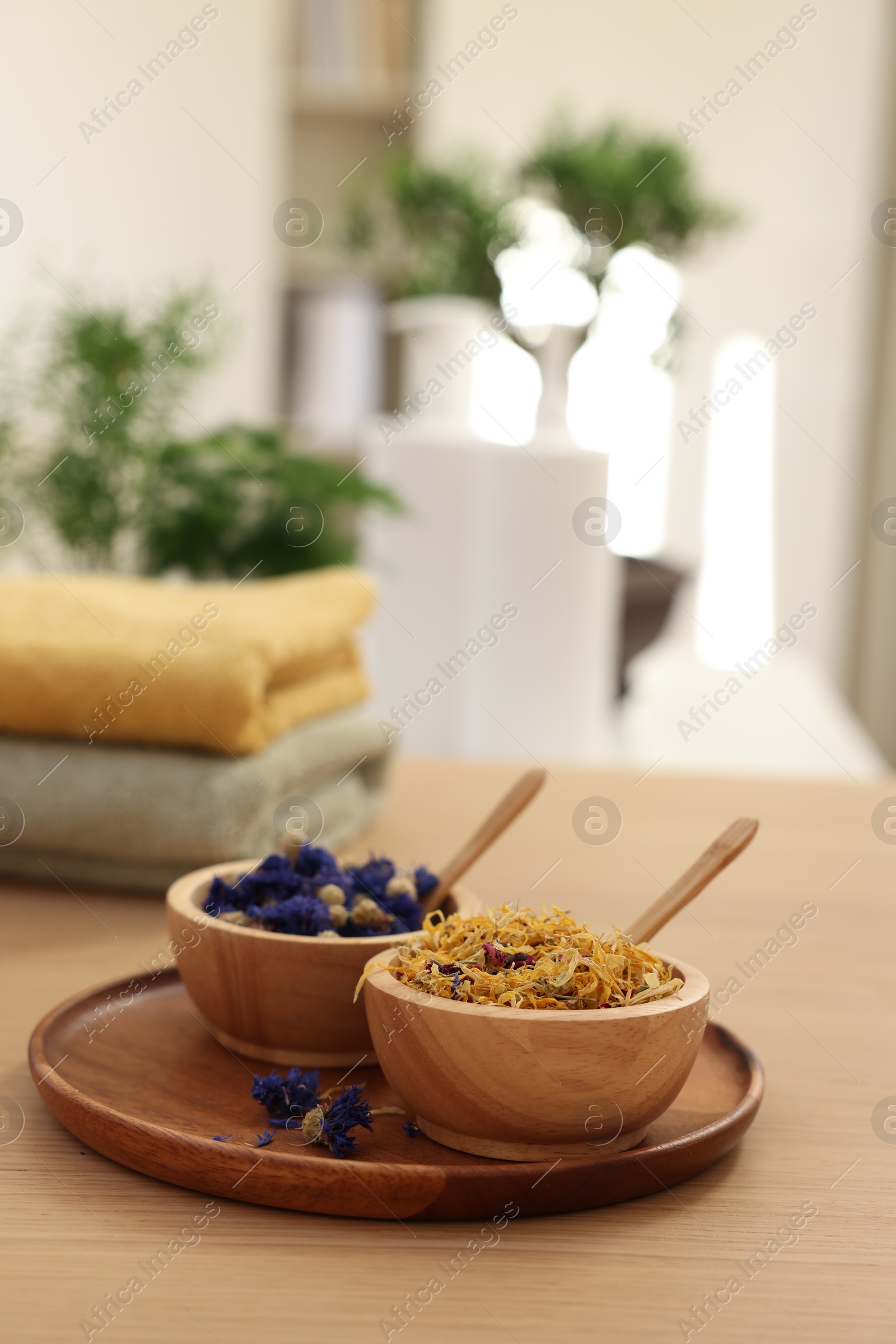 Photo of Dry flowers on wooden table indoors, space for text. Spa time