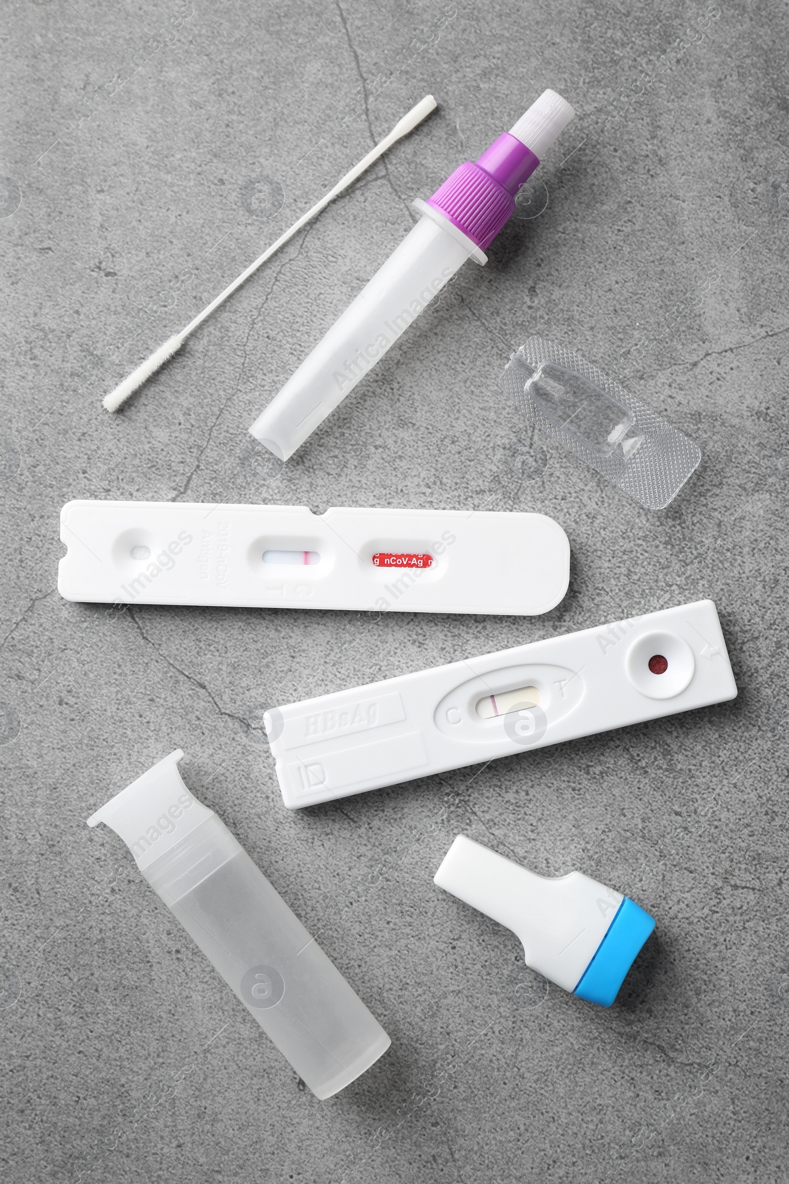 Photo of Disposable express test kits on grey table, flat lay