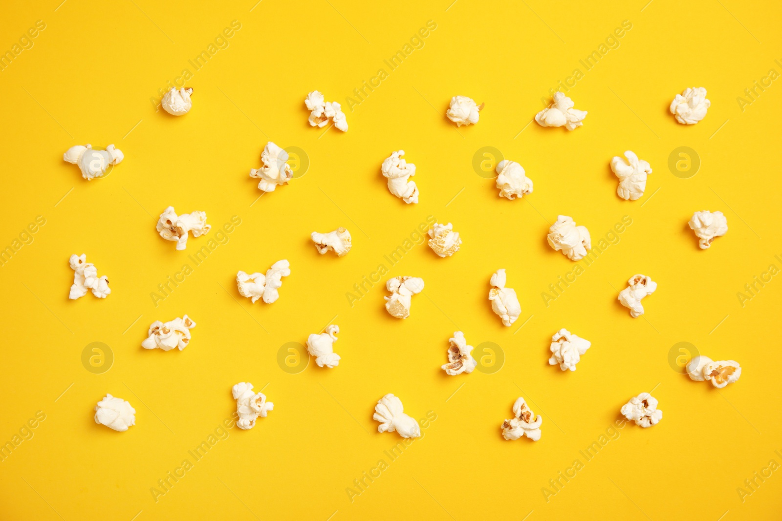 Photo of Tasty fresh popcorn on color background, top view