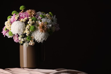 Photo of Bouquet of beautiful chrysanthemum flowers on table against dark background, space for text