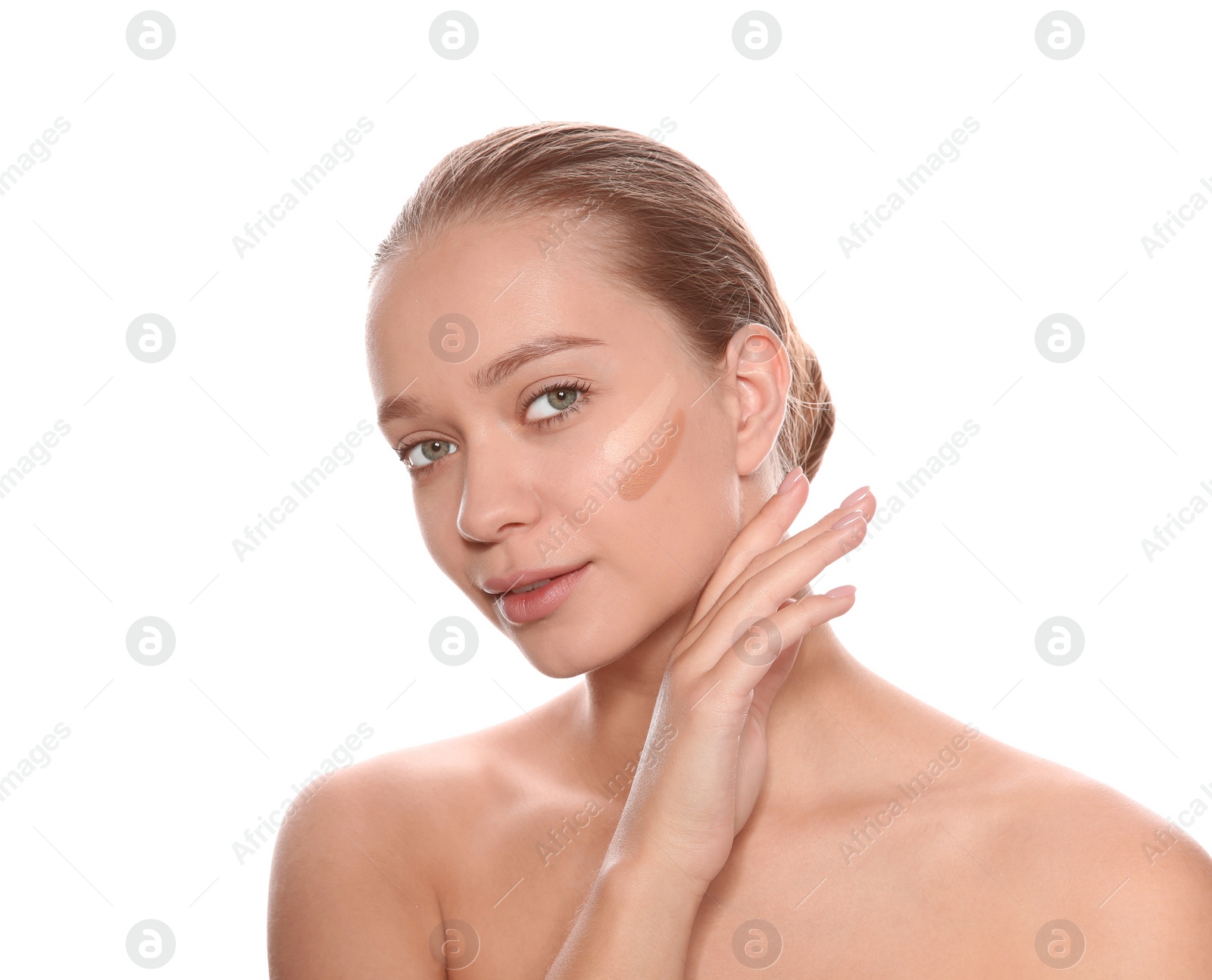 Photo of Young woman with different shades of skin foundation on her face against white background