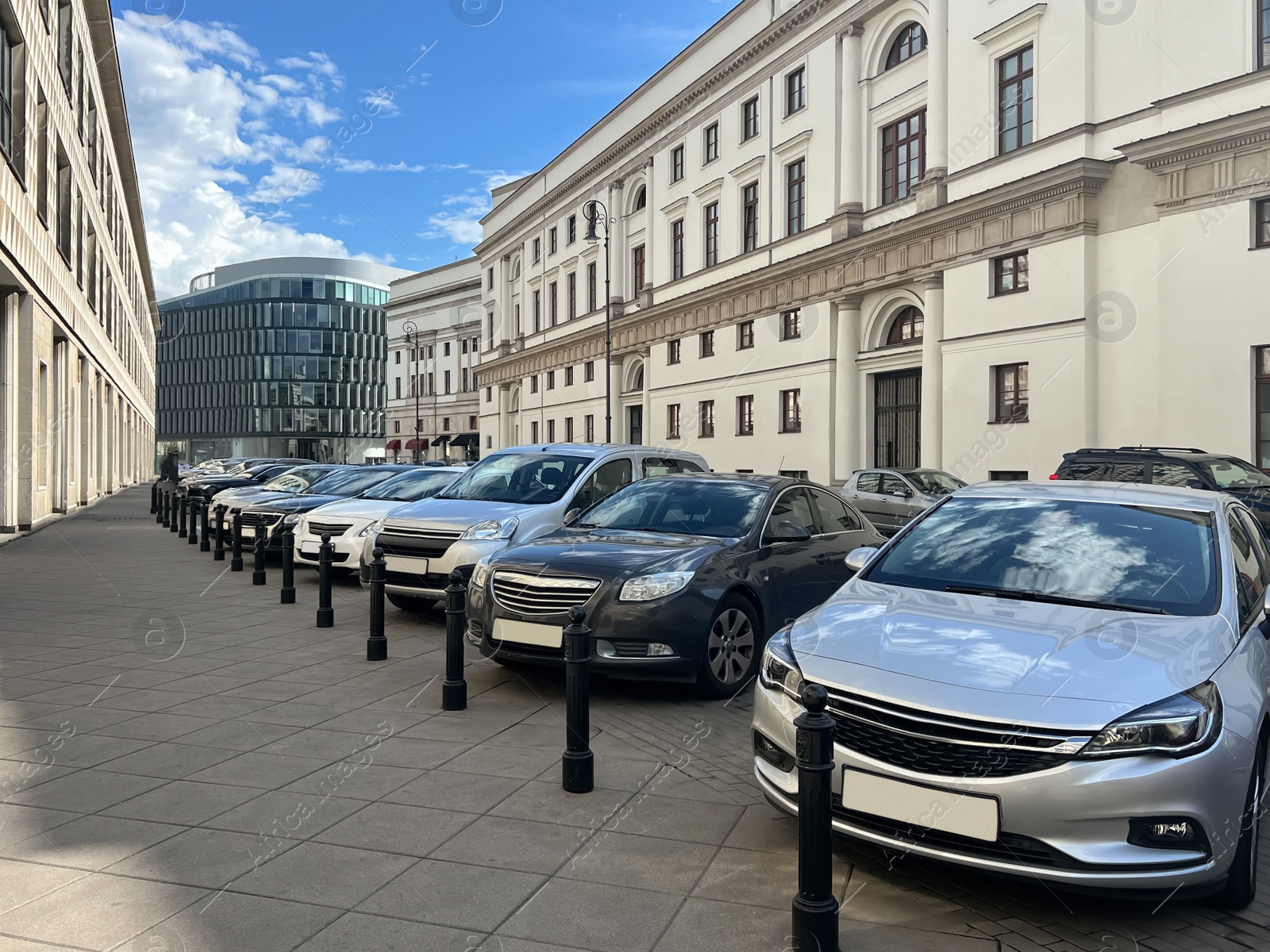 Photo of Different modern cars parked on city street