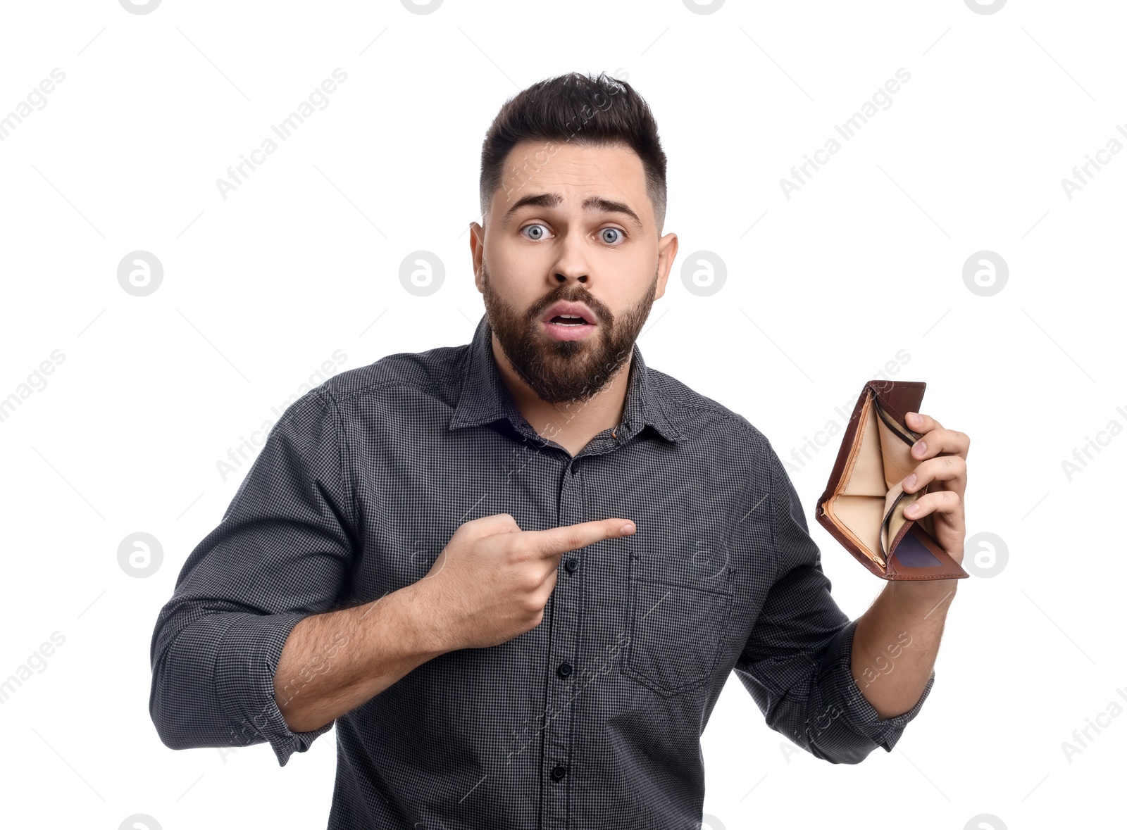 Photo of Confused man pointing at empty wallet on white background