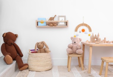 Children's room interior with stylish wooden furniture, toys and decorative elements