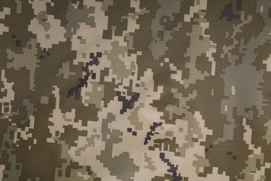 Photo of Texture of camouflage fabric as background, top view