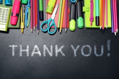 Phrase Thank You! and different school stationery on blackboard, flat lay