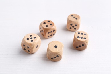 Photo of Many game dices on white wooden table