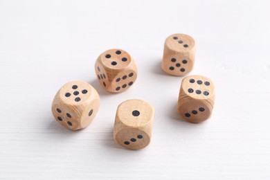 Many game dices on white wooden table