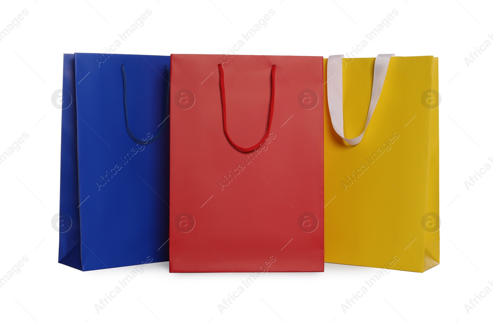 Photo of Colorful paper shopping bags isolated on white