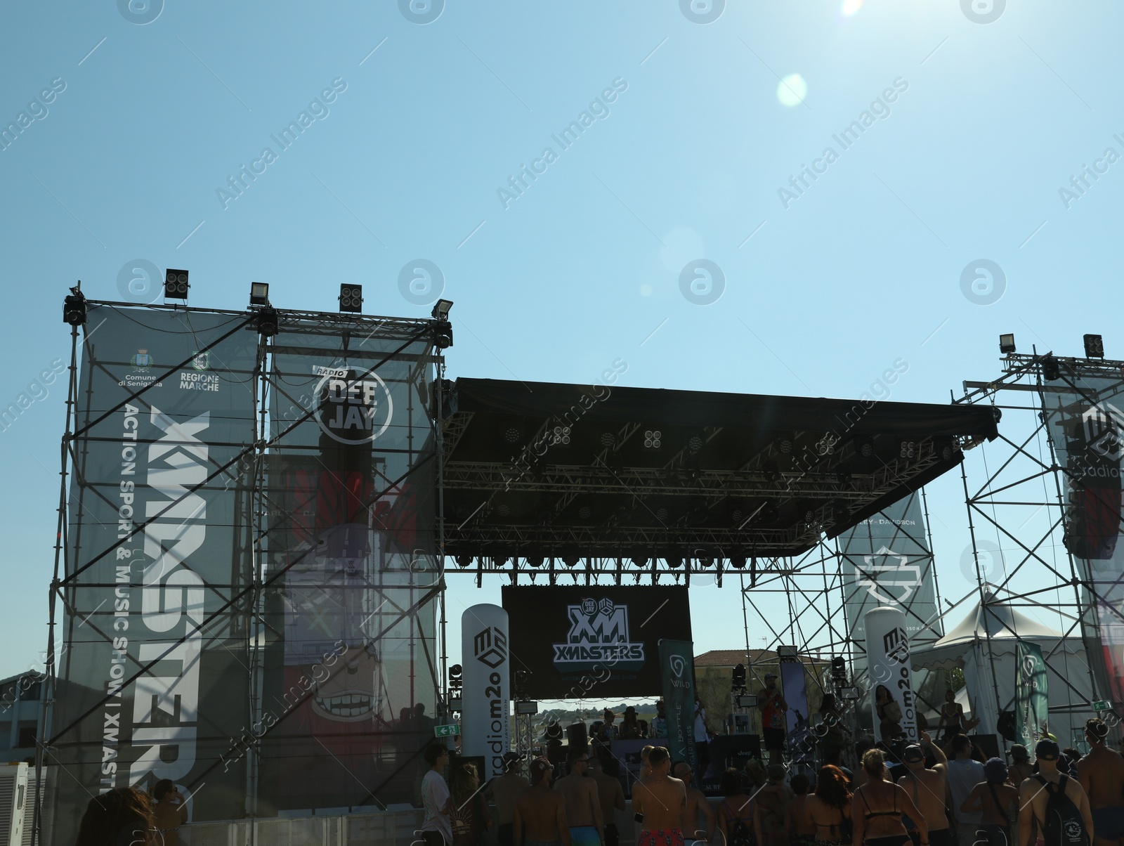 Photo of SENIGALLIA, ITALY - JULY 22, 2022: People enjoying music festival under blue sky