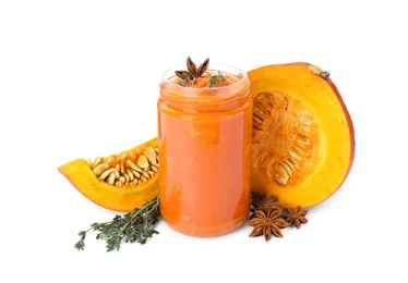 Photo of Jar of pumpkin jam, star anise, fresh pumpkin and thyme on white background