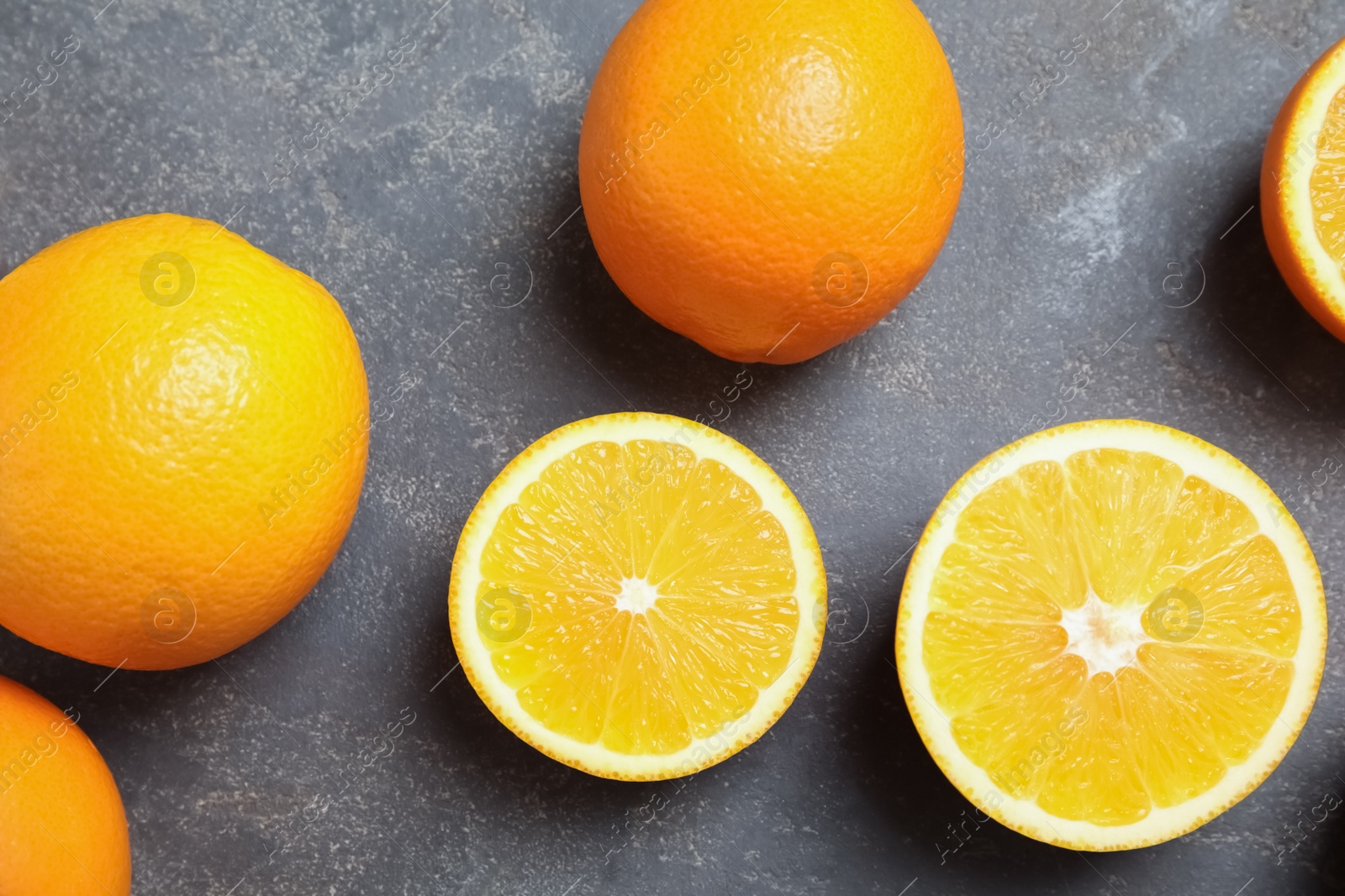 Photo of Flat lay composition with fresh oranges on grey background