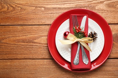 Photo of Beautiful Christmas table setting on wooden background, top view. Space for text