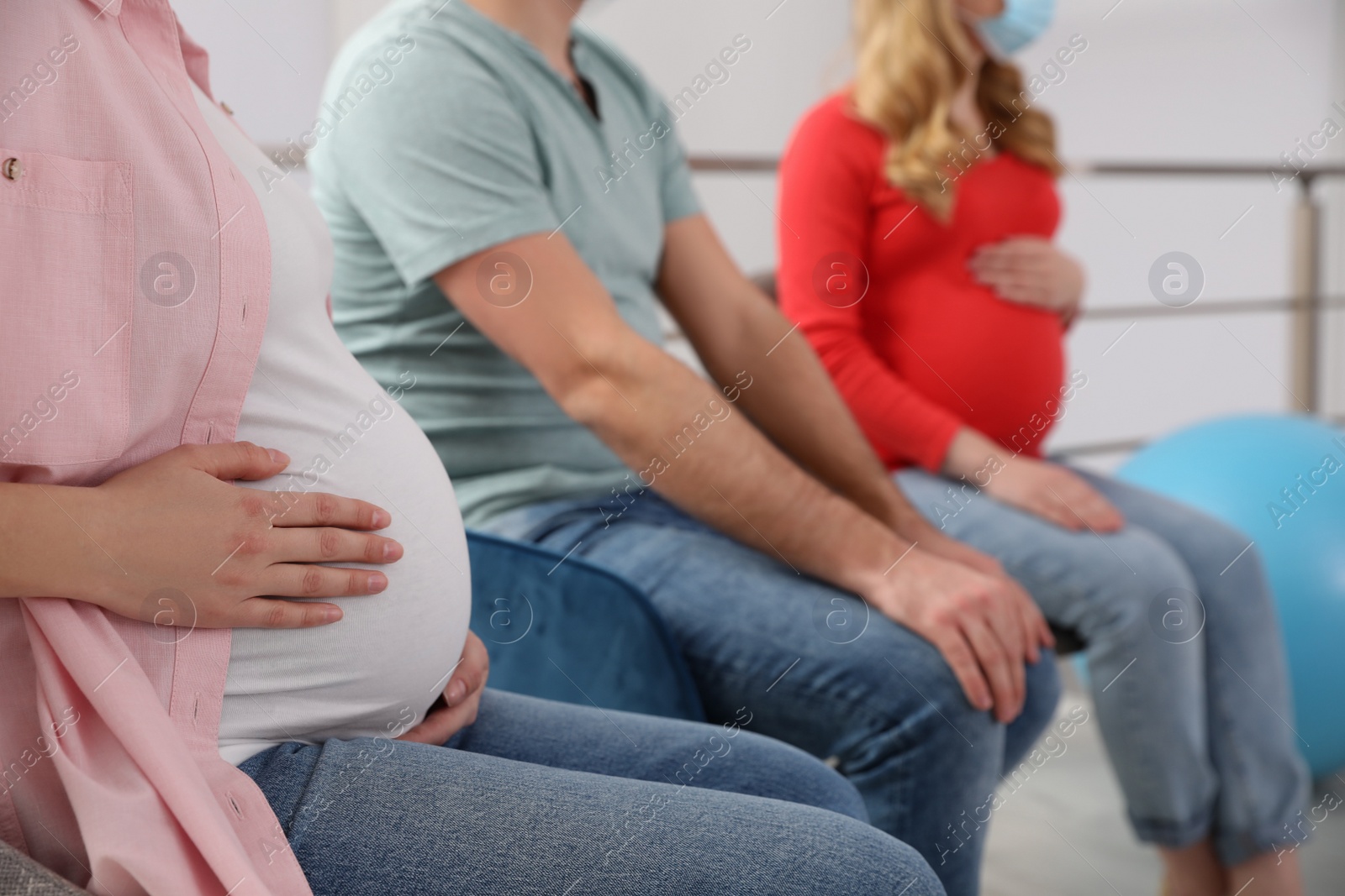 Photo of Pregnant women and man at courses of expectant parents, closeup