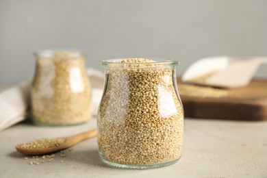 Photo of Jar with white quinoa on light grey table