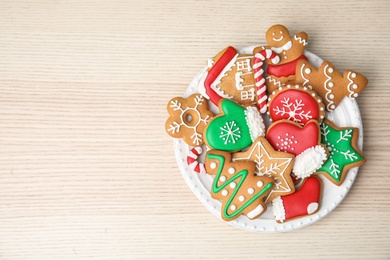 Plate with tasty homemade Christmas cookies on table, top view