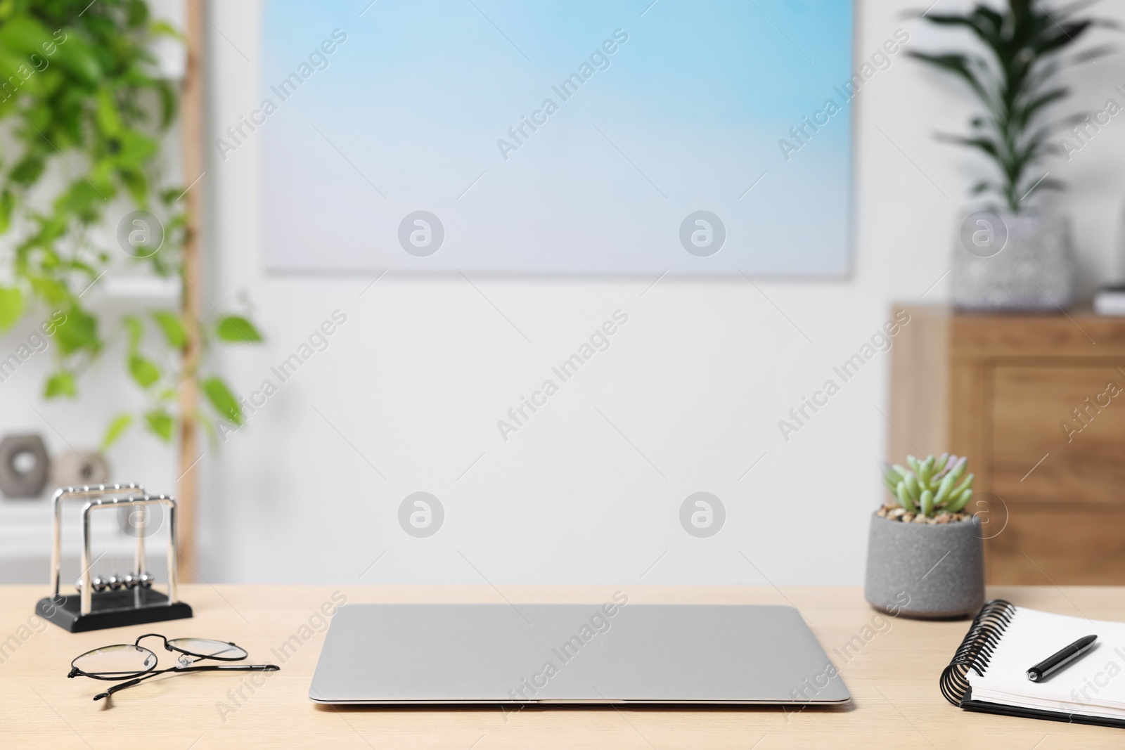 Photo of Home workspace. Laptop and stationery on wooden desk indoors