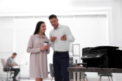 New modern printer on table in office. Space for text