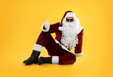 Santa Claus with sunglasses on yellow background