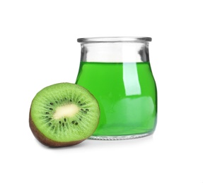 Piece of kiwi and tasty jelly dessert in glass jar on white background