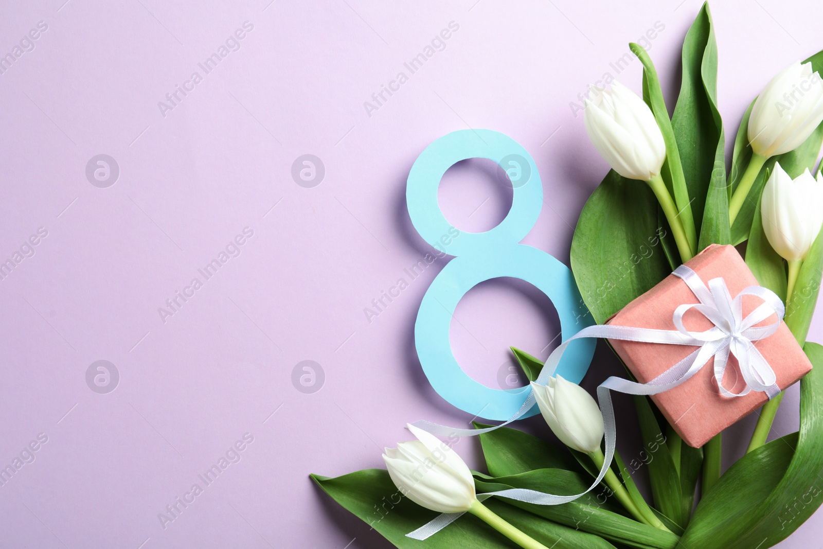 Photo of 8 March card design with tulips, gift and space for text on violet background, flat lay. International Women's Day