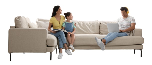 Happy family resting on comfortable sofa against white background