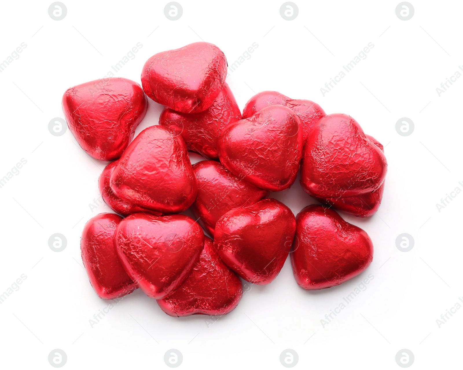 Photo of Heart shaped chocolate candies in red foil on white background, top view