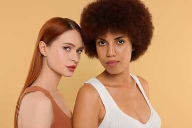 Photo of Portrait of beautiful young women on beige background