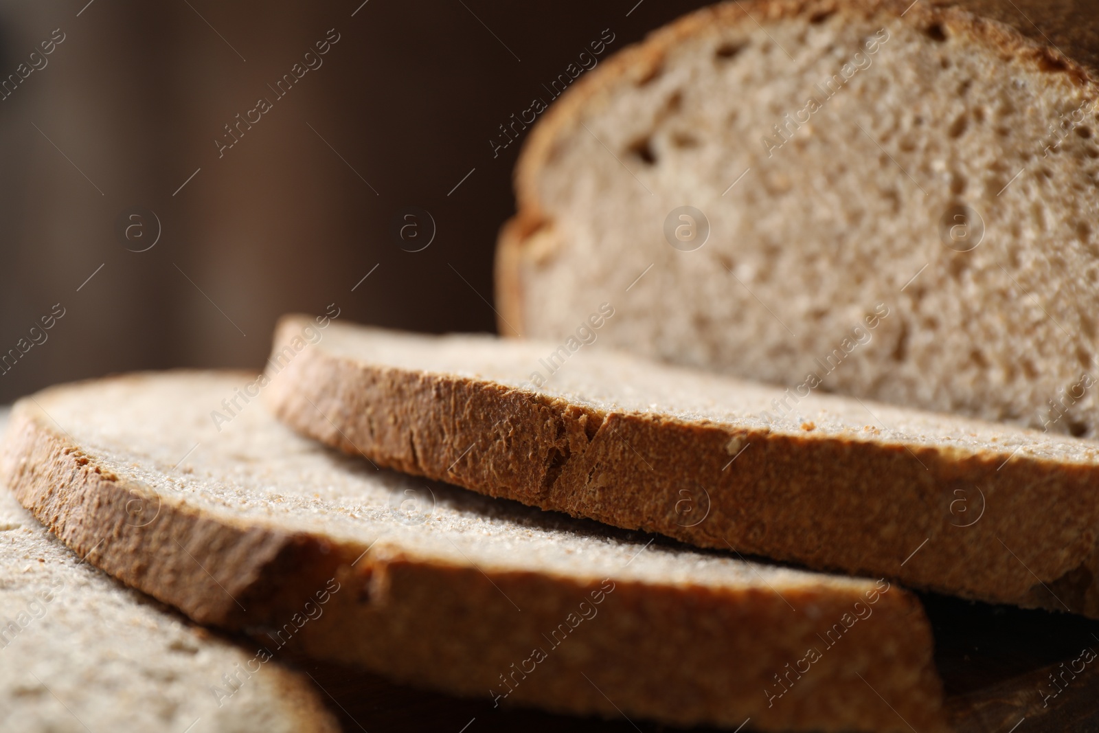 Photo of Freshly baked cut sourdough bread on table, closeup