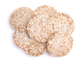 Photo of Many crunchy buckwheat cakes on white background, top view
