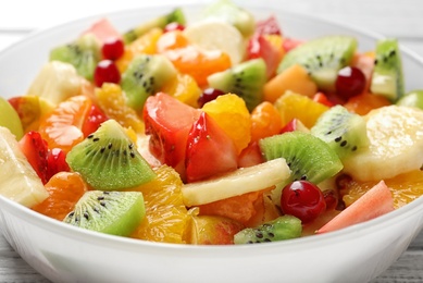 Photo of Bowl with fresh cut fruits, closeup