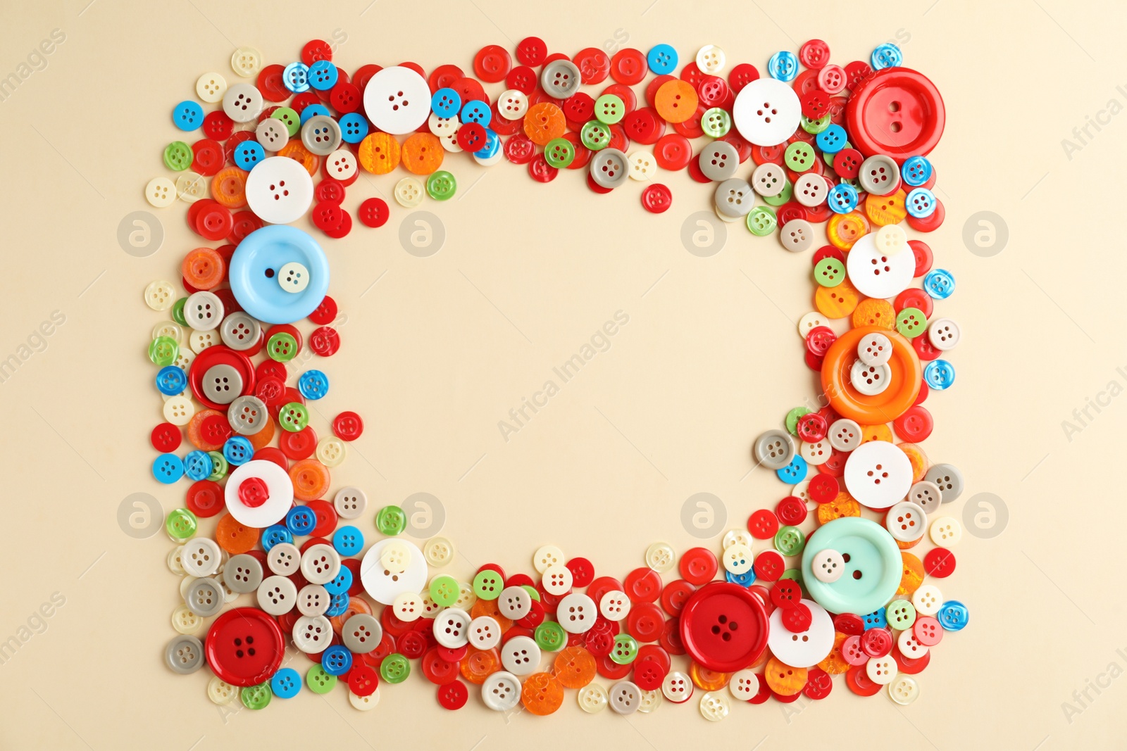 Photo of Frame of colorful sewing buttons on beige background, flat lay. Space for text