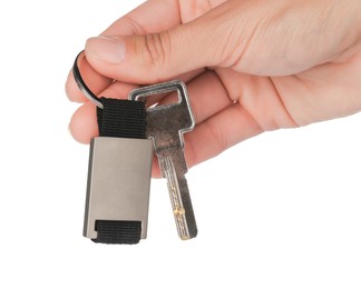 Photo of Woman holding key with metallic keychain on white background, closeup