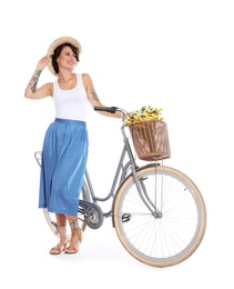 Portrait of beautiful young woman with bicycle on white background