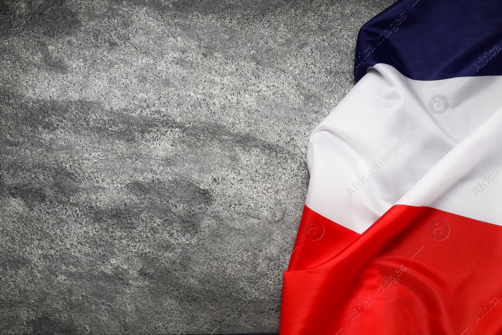 Photo of Flag of France on gray background, top view. Space for text