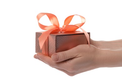 Woman holding pink gift box on white background, closeup