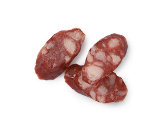 Photo of Pieces of thin dry smoked sausages isolated on white, top view