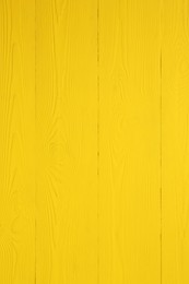 Photo of Texture of yellow wooden surface as background, closeup