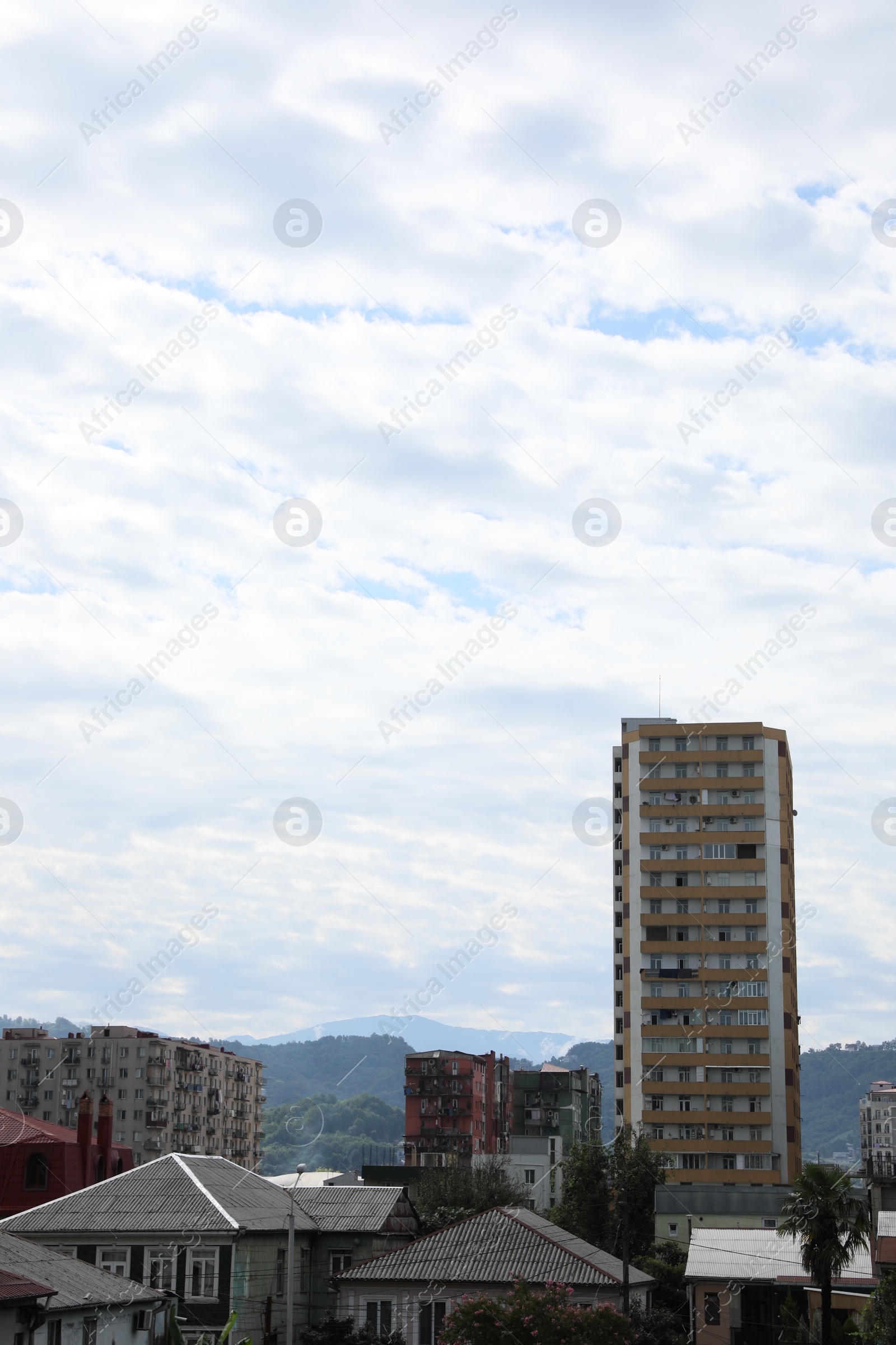 Photo of Beautiful view of different apartment buildings under cloudy sky