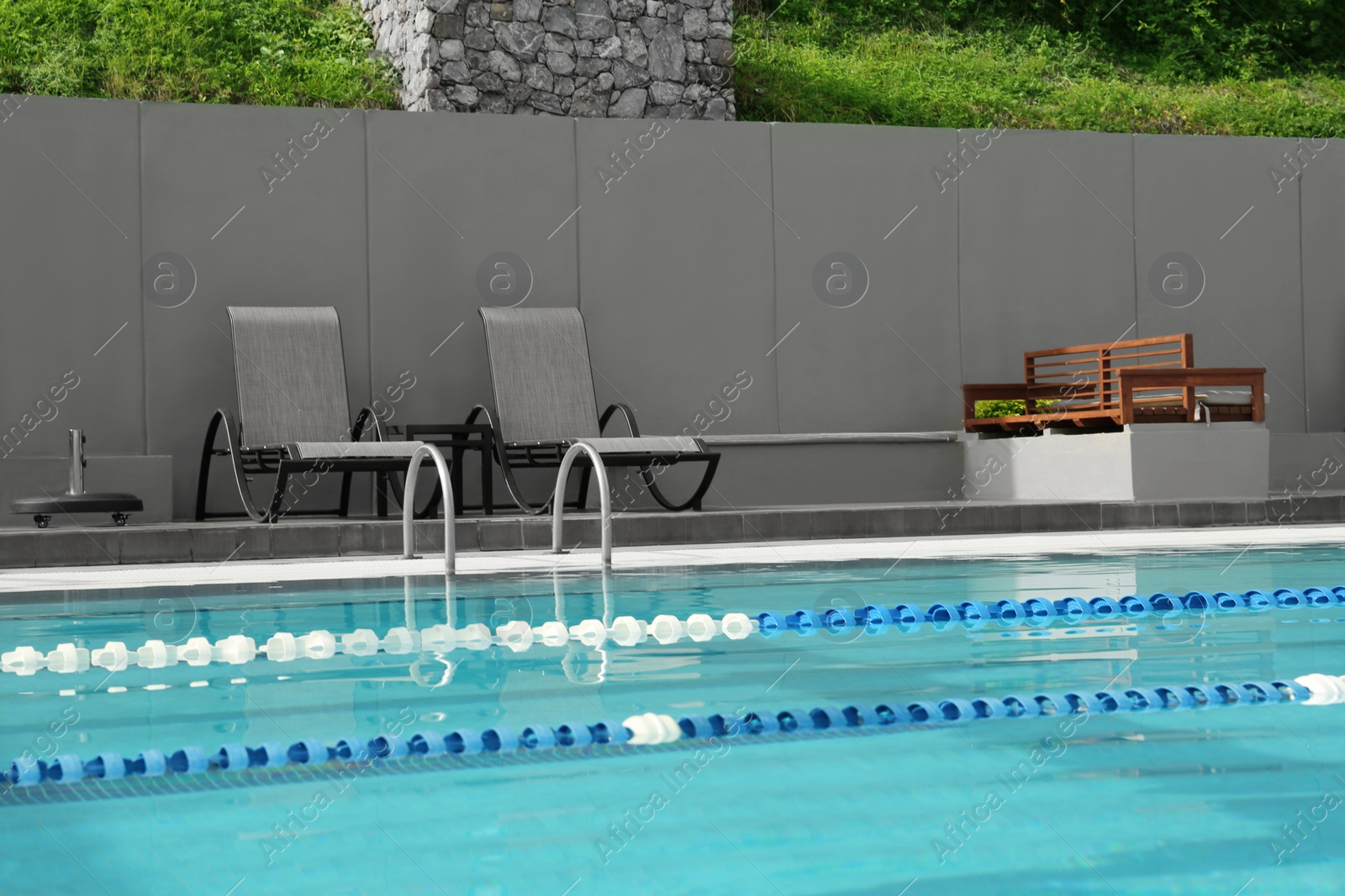 Photo of Ladder with handrails in outdoor swimming pool