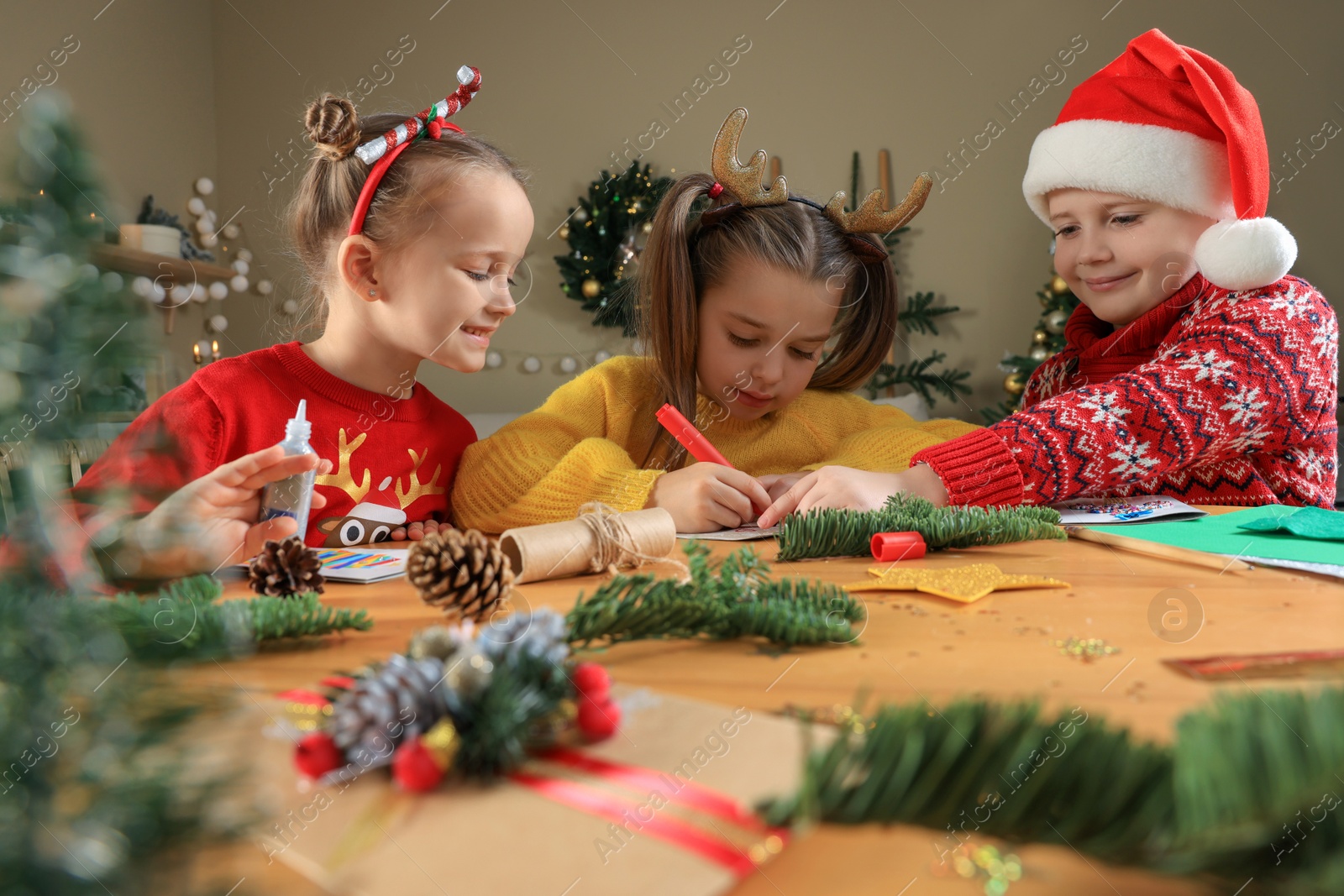 Photo of Cute little children making beautiful Christmas greeting cards at home